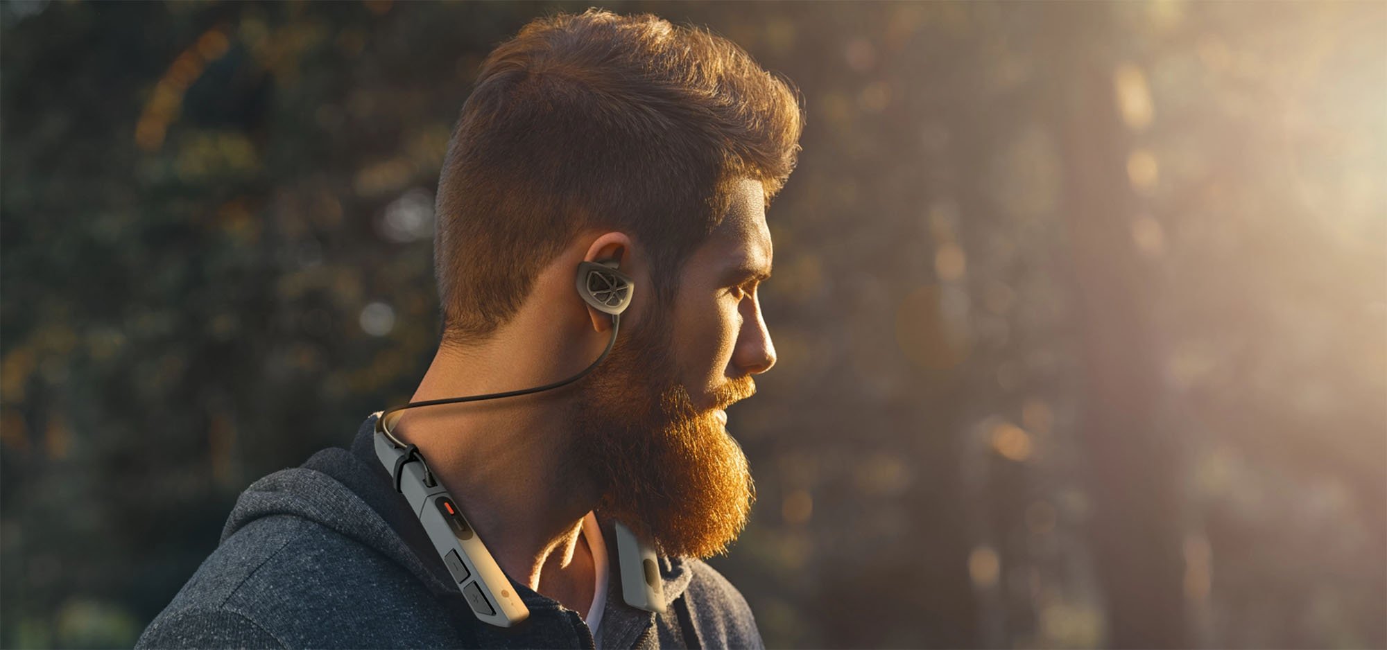 man with beard wearing CLEAR 360 ear protection headset in outdoor setting